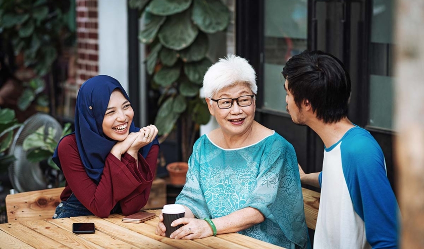 Elderly woman with two young people in Asia