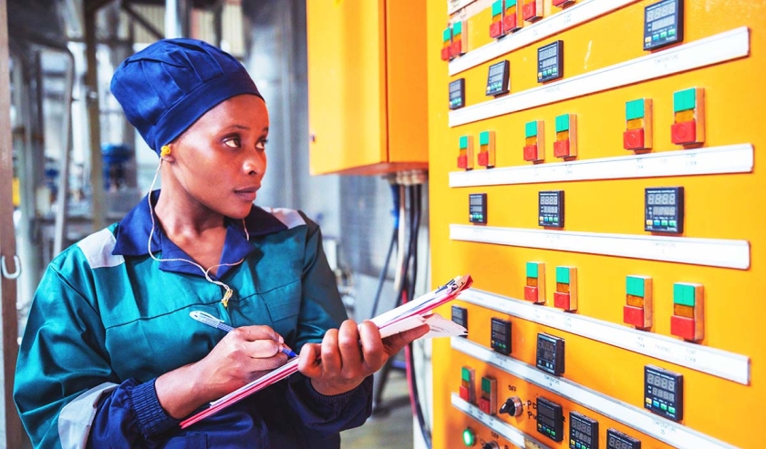 Female Factory Engineer Checking the Electrical Panel