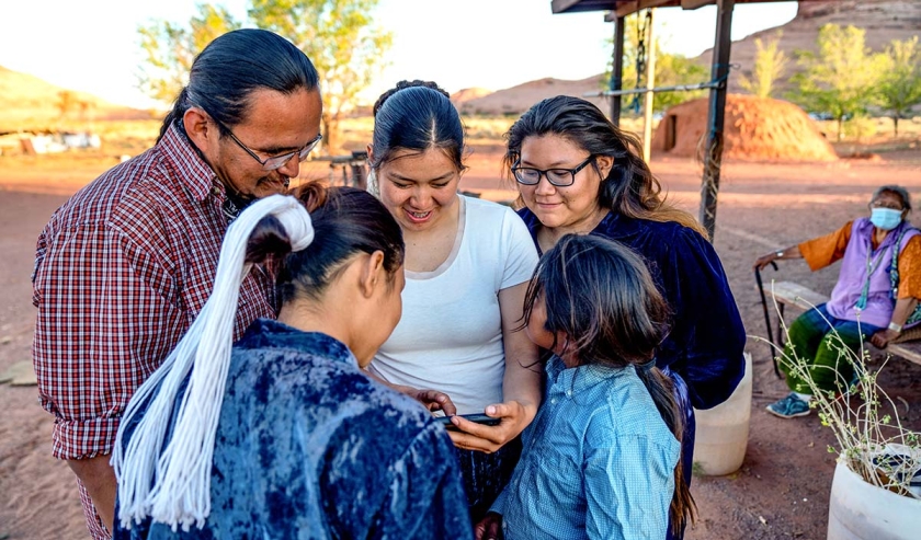 Family Spending Time Sharing Photos from a Smart Phone