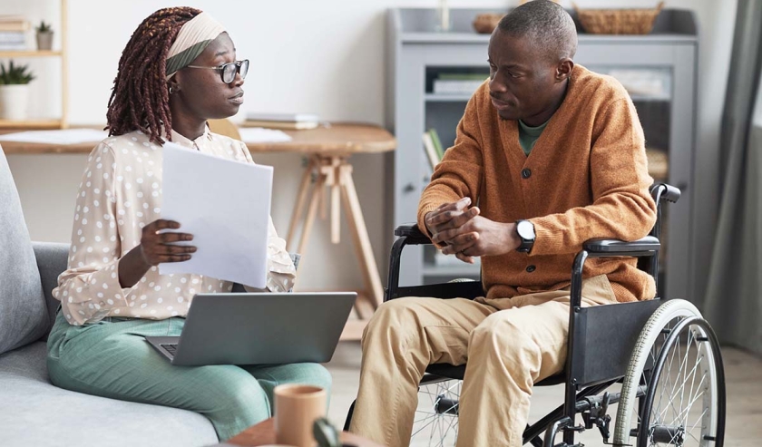 African-American Wheelchair User Talking to Business Consultant 
