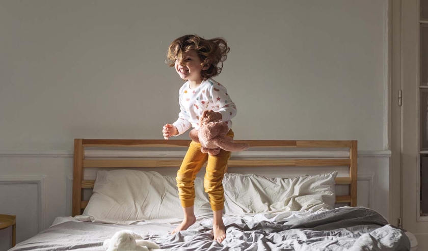 Little Girl Jumping on a Bed