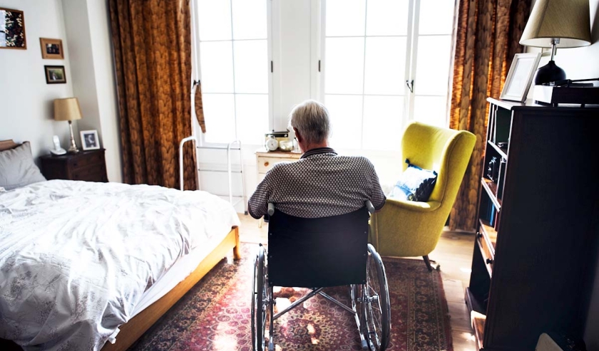 Senior man sitting on the wheelchair alone