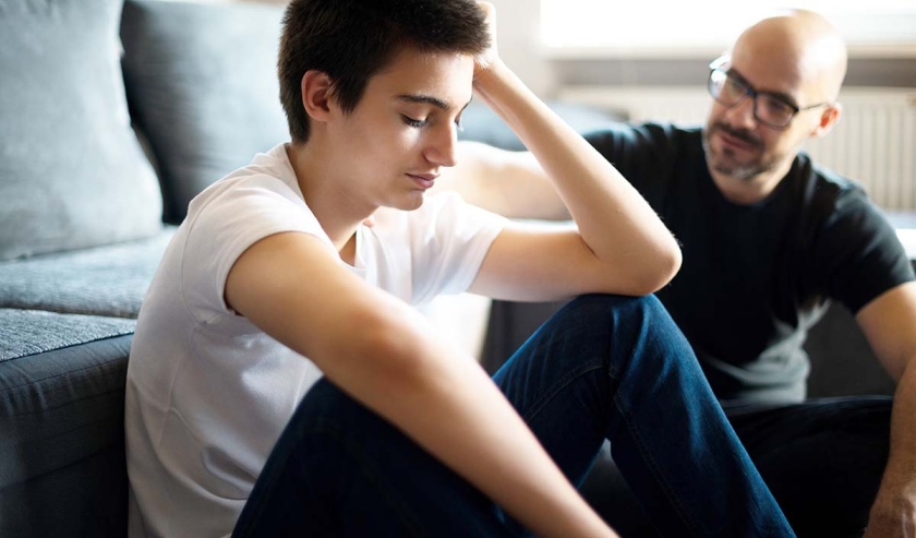 Upset young man talking with his father.