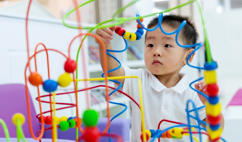 Little boy working on a puzzle