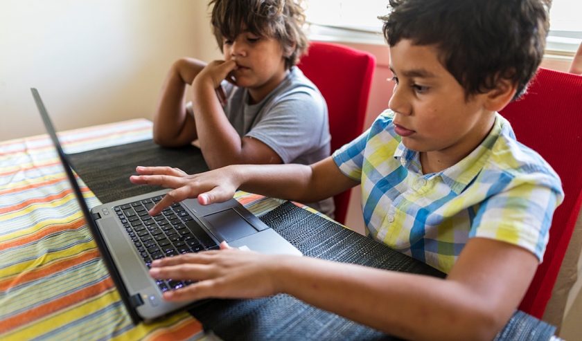 Young Australian Aboriginal Boys Having Fun Playing on a Laptop Computer