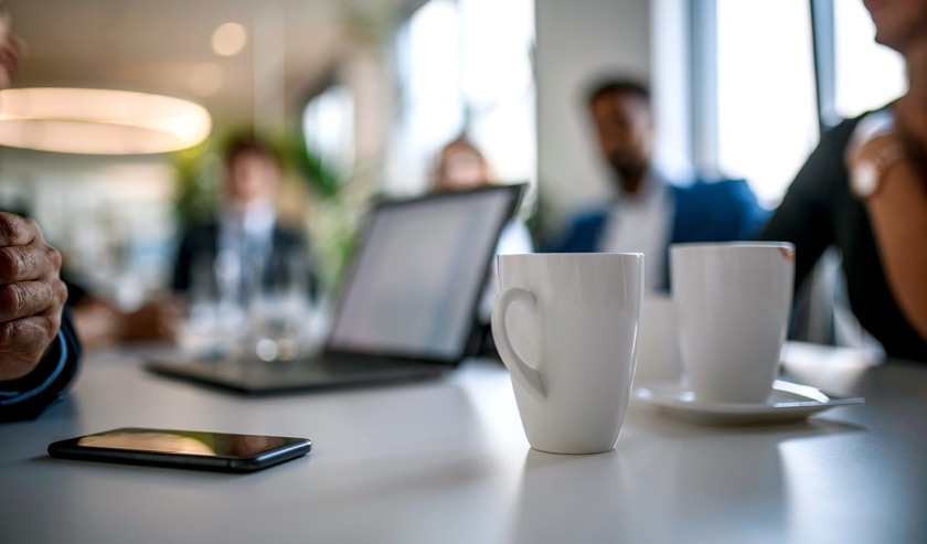 Coffee Mugs and Smart Phone on Conference Table