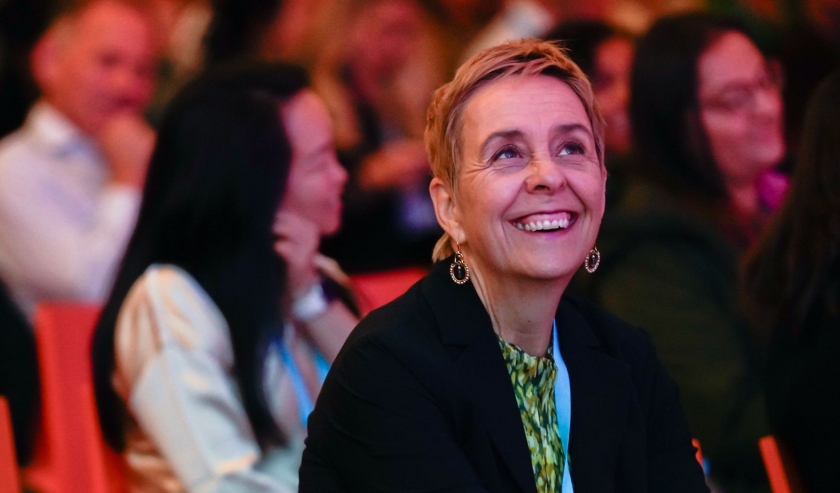 Woman smiling at a conference