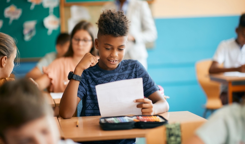 Boy in school classroom reading