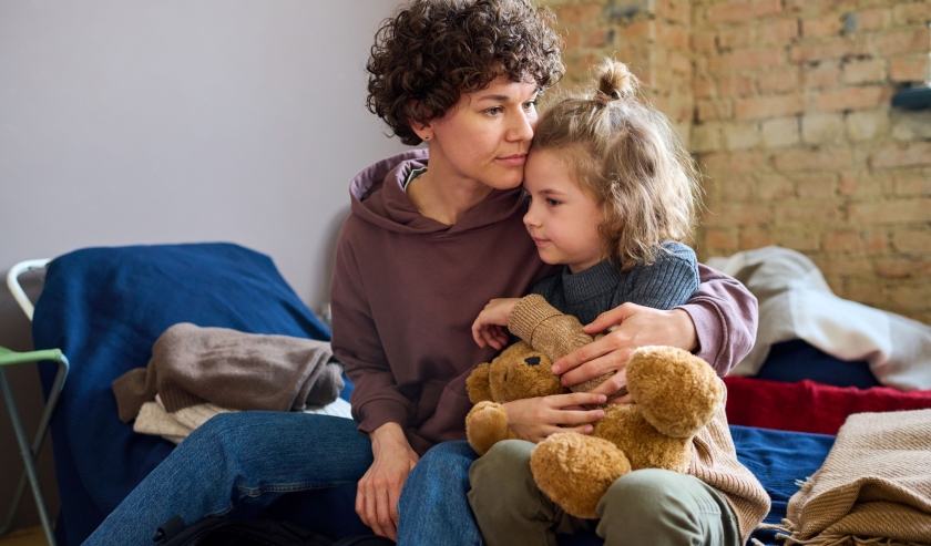 Mother hugging daughter and looking worried