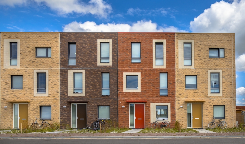 Attached brick housing with blue sky behind