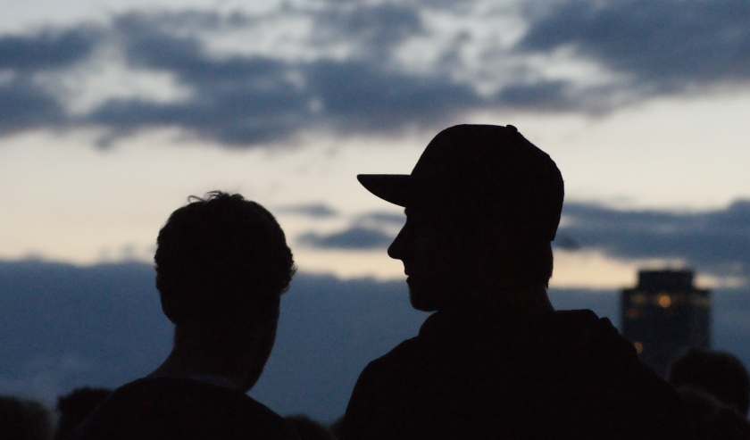 Silhouette figures of people on a sunset background