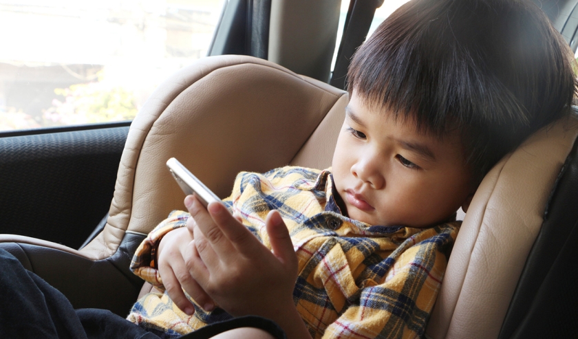 Asian boy looking at smartphone screen