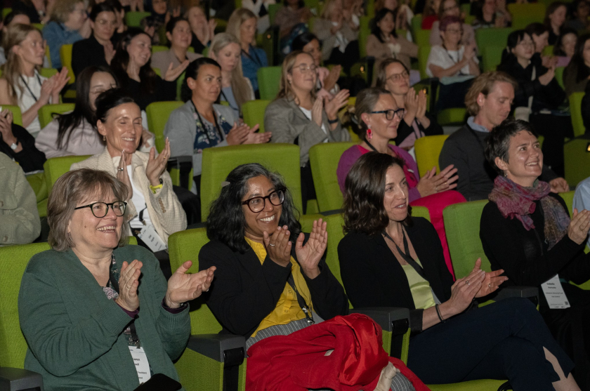 A conference crowd applauding 