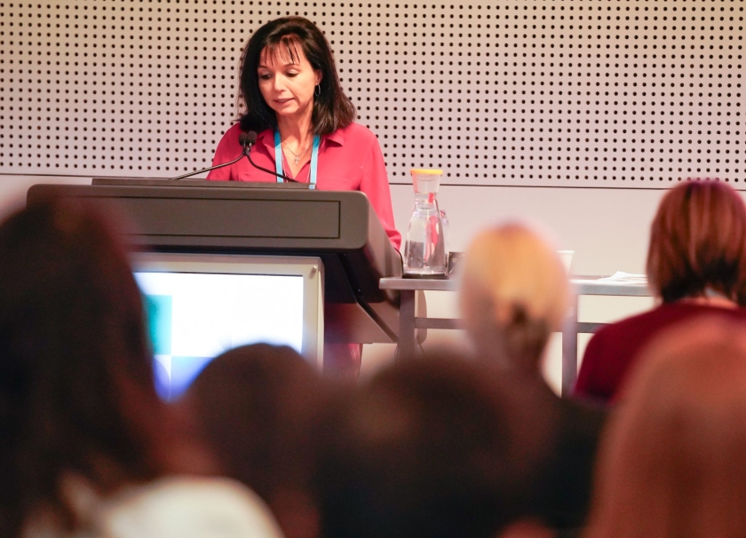 Woman presenting at conference podium