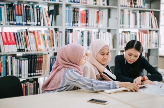 asian university student studying in library