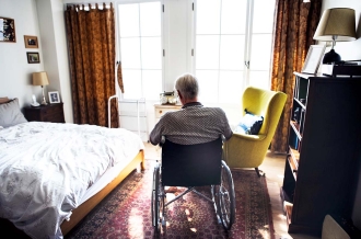 Senior man sitting on the wheelchair alone